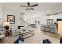 Spacious living room with a ceiling fan, wood floors, and a view into the kitchen at 839 Pensive Run, Dacula, GA 30019