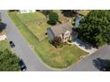Aerial view of a well-maintained property with a spacious backyard, surrounded by lush greenery and neighborhood streets at 900 Cherringham Ct, Alpharetta, GA 30005