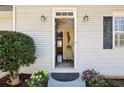 Inviting front entrance with a decorative door, plants, and wall-mounted lighting at 1199 Haven Brook Ne Way, Brookhaven, GA 30319