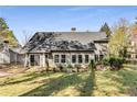 Spacious backyard with lush greenery, a patio, and mature landscaping offers a private retreat at 500 Huntgate Rd, Woodstock, GA 30189