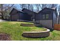 Modern home with stone foundation, terraced yard, and professional landscaping at 2078 Lyle Ave, College Park, GA 30337