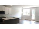 Bright kitchen with a center island, stainless steel appliances, and a door leading to the backyard at 1071 Crest Mill Dr, Marietta, GA 30008