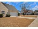 Spacious two-car garage featuring a clean design, complemented by a well-maintained lawn at 2450 Cordillo Ne Dr, Dacula, GA 30019