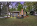Charming home with stone accents, newly landscaped front yard, and inviting wooden front porch, at dusk at 2512 Hidden Hills Dr, Marietta, GA 30066