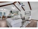 Bright open-concept living room features vaulted ceilings with beams, modern furniture and hardwood floors at 2512 Hidden Hills Dr, Marietta, GA 30066