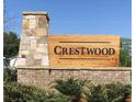 Stone and brick Crestwood community sign with manicured landscaping and a bright blue sky backdrop at 1075 Crest Mill Dr, Marietta, GA 30008