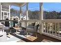 Bright, airy screened porch offers an inviting space with wooded views and comfortable seating arrangement at 2159 James Aly, Atlanta, GA 30345