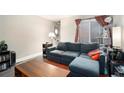 Comfortable living room featuring a gray sectional sofa, a wooden coffee table, and sliding glass doors at 385 Ralph Mcgill Ne Blvd # D, Atlanta, GA 30312
