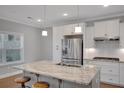 Modern kitchen with granite countertops, stainless steel appliances, and pendant lighting at 541 Glen Abbey Se Cir, Mableton, GA 30126