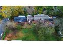 Aerial view of the brick apartment building surrounded by trees, a lawn, and neighborhood streets at 208 Doane St, Atlanta, GA 30315