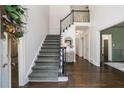 Inviting foyer showcasing the staircase, hardwood floors, and natural light, offering a warm welcome at 12105 Wexford Club Dr, Roswell, GA 30075