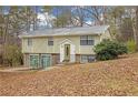 Charming home featuring stone accents and a well-maintained front yard on a wooded lot at 4690 Big Valley Ct, Stone Mountain, GA 30083