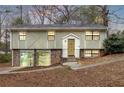 Charming home featuring stone accents and a well-maintained front yard on a wooded lot at 4690 Big Valley Ct, Stone Mountain, GA 30083