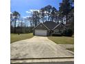 Beautiful brick home with an attached two-car garage, and a large front yard at 104 Oak Bend Dr, Stockbridge, GA 30281