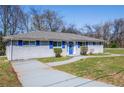 A charming single-story home with blue shutters, blue front door, and mature trees at 1393 Vesta Ave, Atlanta, GA 30344