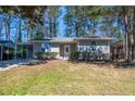 Charming single-story home featuring a well-maintained lawn and inviting front entrance at 1780 Brewer Sw Blvd, Atlanta, GA 30310
