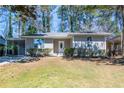 Charming single-story home featuring a well-maintained lawn and inviting front entrance at 1780 Brewer Sw Blvd, Atlanta, GA 30310