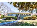 Inviting single-story home with fresh landscaping and a welcoming front entrance with recently painted stairs at 264 Silver Springs Sw Cir, Atlanta, GA 30310