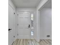 Bright foyer with hardwood floors, a sidelight window, and views of the house's interior at 2887 Hickory Ln, Snellville, GA 30078