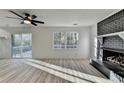 Cozy living room with hardwood floors, a fireplace, and a sliding glass door to the backyard deck at 2887 Hickory Ln, Snellville, GA 30078