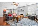 Cozy living room featuring a fireplace, ceiling fan, and hardwood flooring at 1401 Keys Crossing Ne Dr, Atlanta, GA 30319