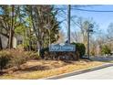 Entrance sign to Keys Crossing Condominiums with beautiful landscaping at 1401 Keys Crossing Ne Dr, Atlanta, GA 30319