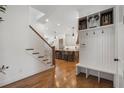 Inviting entryway with hardwood floors, a built-in bench, and views of the kitchen at 557 Stone Field Nw Run, Marietta, GA 30060