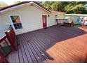 Beautiful wooden deck with bench and red door at 615 Woodruff Rd, Carrollton, GA 30116