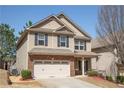 Charming two-story home with a brick and siding facade and a two-car garage at 2409 Brynfield Cv, Suwanee, GA 30024
