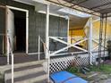 Exterior porch with steps, peeling paint, and a doorway into the home's interior at 406 Dallas Hwy, Villa Rica, GA 30180
