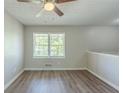 Bright bedroom featuring new floors, neutral paint, ceiling fan and a large window at 1477 Patricia Dr, Morrow, GA 30260
