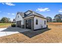 Attached two car garage with a modern design, stone accents and a long driveway at 4285 Haynes Cir, Snellville, GA 30039