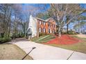 Beautiful two-story home with a driveway, landscaping, and a brick facade at 2542 Ashridge Ct, Lawrenceville, GA 30043