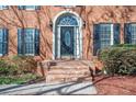 Elegant front door with arched transom window and brick steps at 2542 Ashridge Ct, Lawrenceville, GA 30043