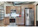 Modern kitchen features stainless steel appliances, tile backsplash and wooden cabinetry at , Atlanta, GA 30309