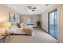 Cozy bedroom featuring neutral carpeting, a sliding glass door, and lots of natural light at 4062 Wildflower Ln, Tucker, GA 30084
