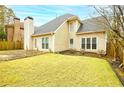 Home exterior featuring a well-manicured lawn, a patio, and windows bringing in natural light at 2698 Glenrose Hl, Atlanta, GA 30341