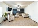 Spacious living room with patterned accent wall, fireplace, and large sofa at 3196 Moon Stone Ln, Snellville, GA 30039