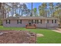 Attractive home featuring a well-kept lawn and inviting front porch at 3618 Mansfield Ln, Snellville, GA 30039