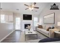 Bright living room with fireplace, ceiling fan, vaulted ceiling, and a calming color palette at 1202 W Briar Gate Ct, Riverdale, GA 30296