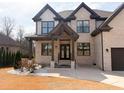 Charming covered front porch and beautiful glass and iron front door creating a welcoming entrance at 1952 Azalea Dr, Lawrenceville, GA 30043