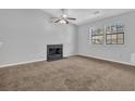Living room features neutral walls, carpet, fireplace, and bright natural light at 2044 Teal Cv, Lithonia, GA 30058