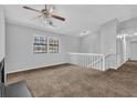 Neutral living room featuring a ceiling fan, large windows and cozy carpet at 2044 Teal Cv, Lithonia, GA 30058