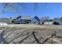 Large backyard view with a wooden deck, offering privacy and space at 2467 Sky Valley Dr, Dacula, GA 30019