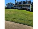 Inviting two-story home with a classic covered porch and well-maintained landscaping at 2467 Sky Valley Dr, Dacula, GA 30019