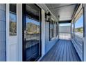 Inviting front porch showcasing blue wood planking and a stylish storm door entry at 2467 Sky Valley Dr, Dacula, GA 30019