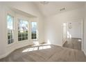 Sun-filled bedroom featuring plush carpeting, a large bay window, and neutral decor at 428 Riverwood Pass, Dallas, GA 30157