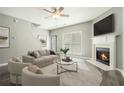 Bright living room featuring a fireplace, ceiling fan, and modern decor for comfortable living at 1954 Durwood Ln, Duluth, GA 30096