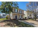 Charming two-story home with a manicured lawn, inviting entrance, and a long concrete driveway at 201 Coral Cir, Mcdonough, GA 30253