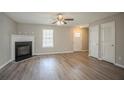 Bright and airy living room featuring hardwood floors, fireplace, and a welcoming front door at 201 Coral Cir, Mcdonough, GA 30253